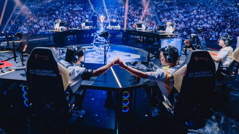 Professional esports team discussing strategy in a practice room before a tournament match